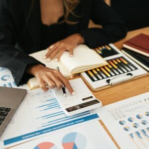 Business women working with calculator, business document and laptop computer notebook, financial