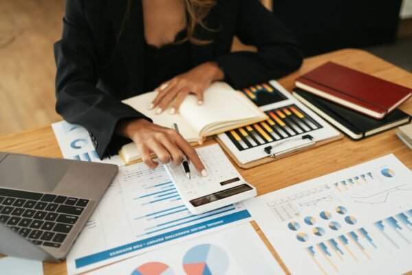 Business women working with calculator, business document and laptop computer notebook, financial